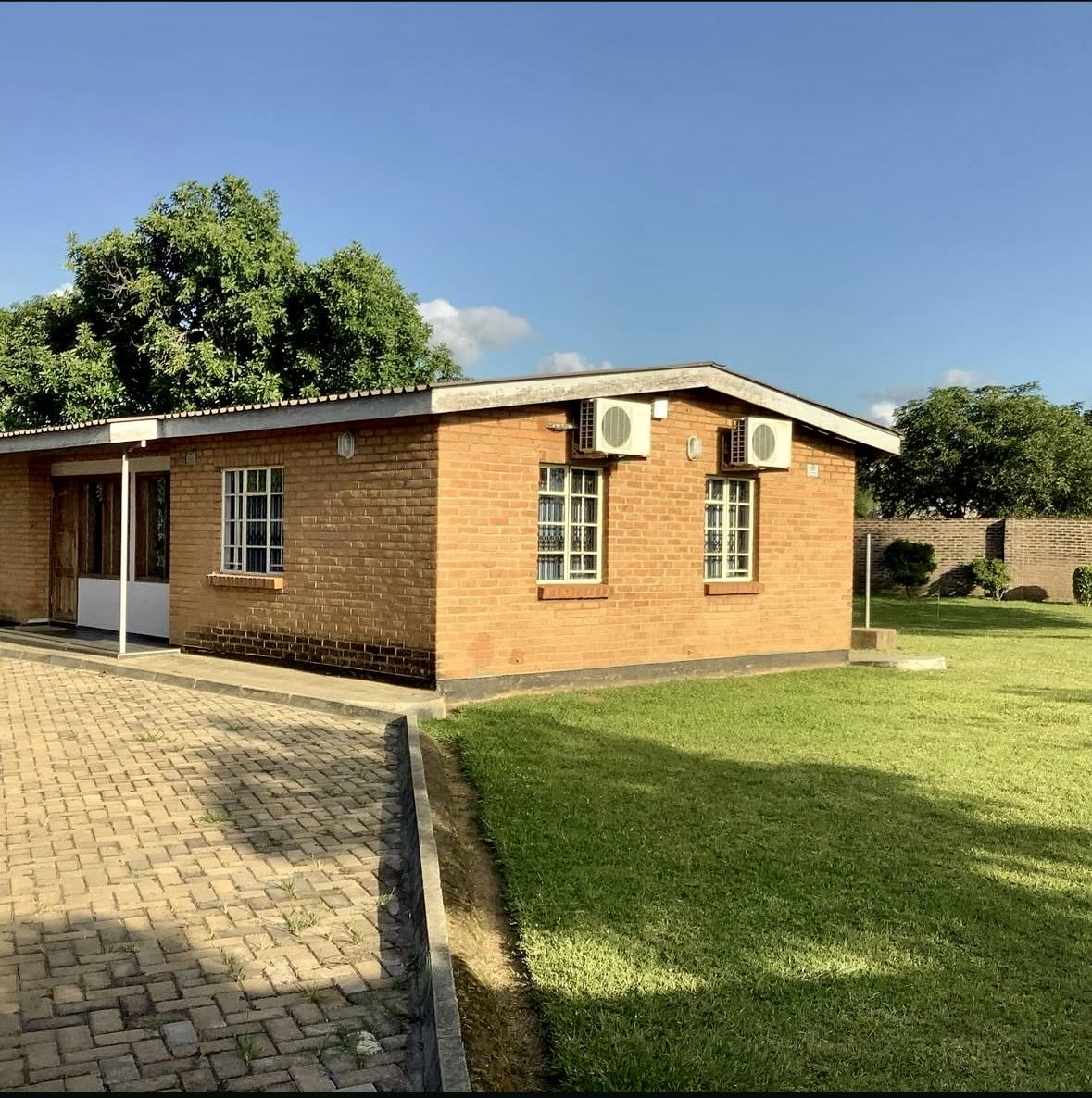 Finished brick building with paved forecourt