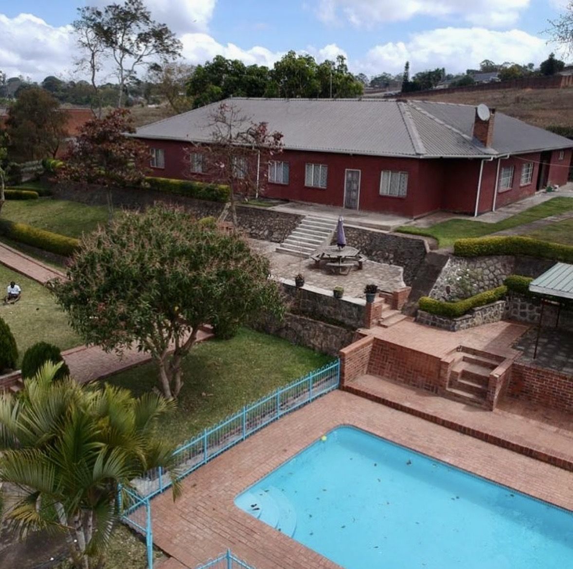 Residential property with pool, brick terraces and landscaped gardens